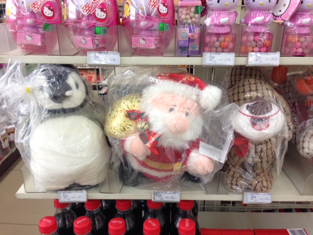 Santa sits next to a penguin and a puppy. Hey Santa, where is your sax!?